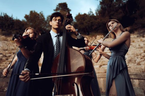 three musicians in blue dress and one musician in black suit in ancient theater. - concert stock pictures, royalty-free photos & images