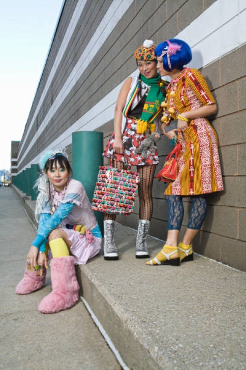 three women on sidewalk - fashion stock pictures, royalty-free photos & images