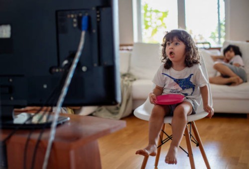 three year old boy eating in front of a television and surprised from what he see - junk food stock pictures, royalty-free photos & images