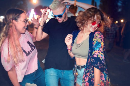 three young friends dancing at outdoor music festival - concert stock pictures, royalty-free photos & images