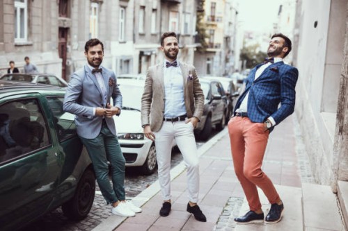 three young good looking tailors laughing on the street - fashion stock pictures, royalty-free photos & images