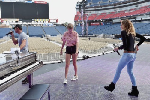 Tim McGraw, Taylor Swift and Faith Hill take photos during rehearsal onstage before the reputation Stadium Tour at Nissan Stadium on August 25, 2018...