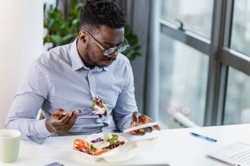 time for lunch and surfing the web on a mobile phone - junk food stock pictures, royalty-free photos & images
