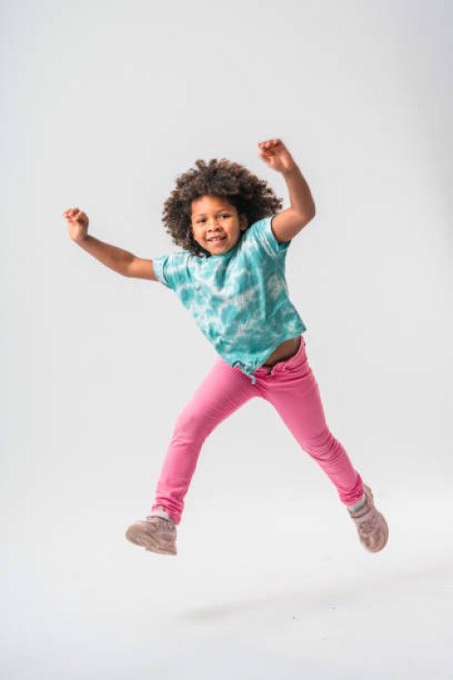 tiny caribbean girl jumping with joy - fashion stock pictures, royalty-free photos & images