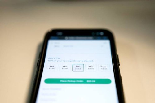 Tip options for take-out food are displayed on a phone screen in Washington, DC, on March 17, 2023. - To tip, or not to tip? That is the question...