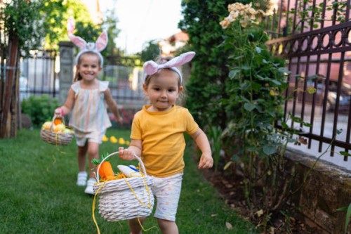 toddler girl running with an easter basket full of easter eggs - garden decoration stock pictures, royalty-free photos & images