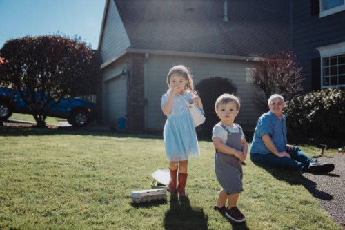 toddler siblings begin an easter egg hunt outside their home - garden decoration stock pictures, royalty-free photos & images
