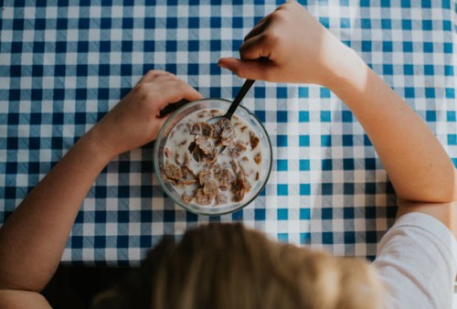 top down image of a child eating cereal - junk food stock pictures, royalty-free photos & images