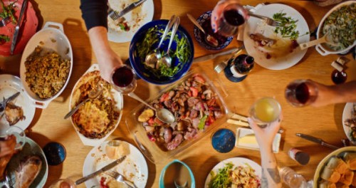 top down shot of guests raising glasses at thanksgiving dinner table - food stock pictures, royalty-free photos & images