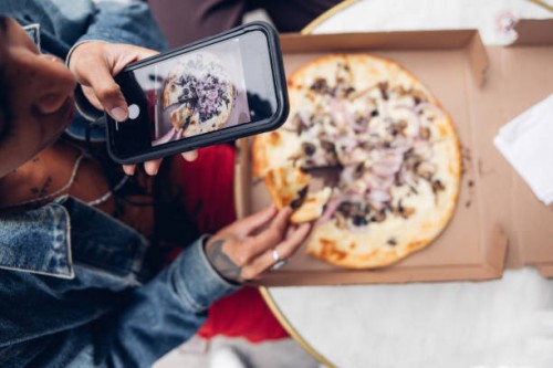 top down view of an italian pizza in new york being posted on social media - junk food stock pictures, royalty-free photos & images