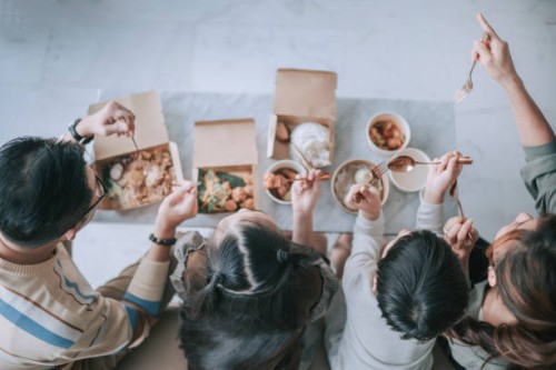 top view asian chinese young family enjoying take out food in front of tv in living room during weekend - junk food stock pictures, royalty-free photos & images