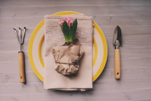 top view of table decorated for easter with hyacinth flower, garden tools and colorful plate. cozy h - garden decoration stock pictures, royalty-free photos & images