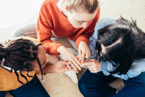 top view of three friends sitting on the floor. - nails art stock pictures, royalty-free photos & images