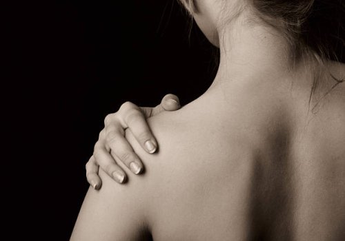 topless woman holding onto shoulder - nails art stock pictures, royalty-free photos & images
