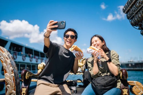 tourist couple taking selfie with smart phone while experiencing and eating street food during their travel - travel stock pictures, royalty-free photos & images