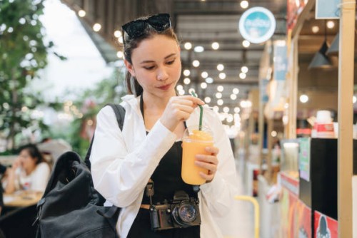 tourist enjoying eating at street food - junk food stock pictures, royalty-free photos & images