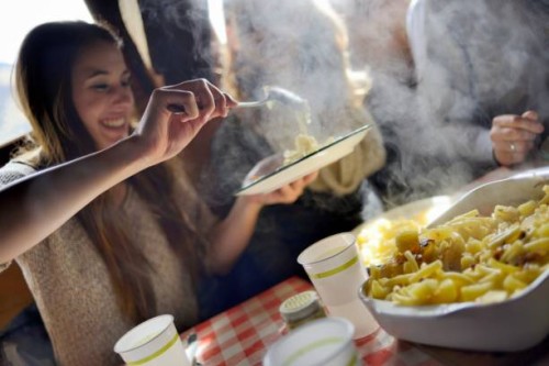 tourist enjoying traditional swiss meal alplermagronen - food stock pictures, royalty-free photos & images