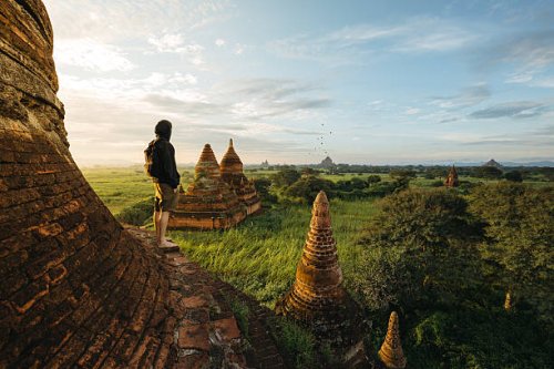 tourist standing on bagan pagoda during sunrise in myanmar - travel stock pictures, royalty-free photos & images