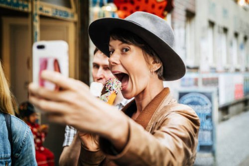 tourist taking selfie while easting an ice cream - food stock pictures, royalty-free photos & images