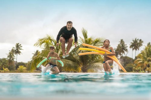 tourists bathing in resort swimming pool - travel stock pictures, royalty-free photos & images