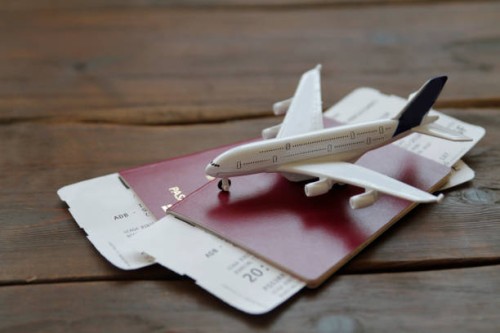 toy airplane with passports and flight booking ticket. travel concept. - travel stock pictures, royalty-free photos & images