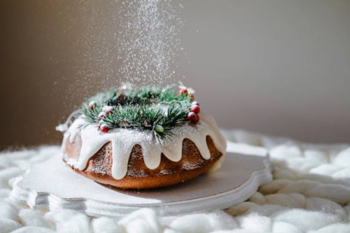 traditional christmas lemon bundt cake decorated with spruce branch and cranberrys. - food stock pictures, royalty-free photos & images