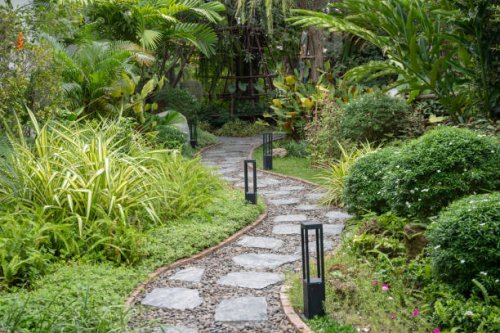 tranquil stone path through a lush tropical garden - garden decoration stock pictures, royalty-free photos & images