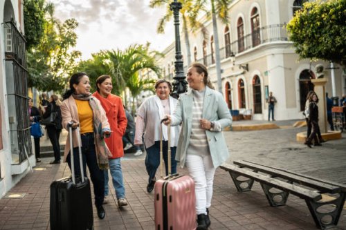 traveler senior friends walking with suitcases outdoors - travel stock pictures, royalty-free photos & images