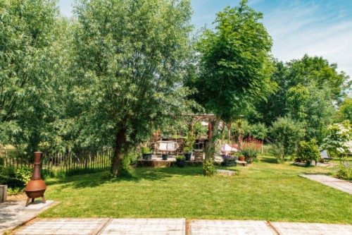 trendy boho garden in the netherlands with a patio and lounge chairs. - garden decoration stock pictures, royalty-free photos & images