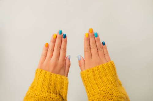 trendy bright manicure on woman hands in illuminating yellow knitted sweater against ultimate gray background. trendy colors of the year 2021. flat lay style. close-up - nails art stock pictures, royalty-free photos & images