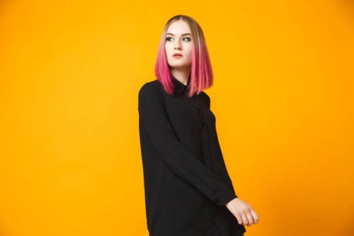 trendy female posing on orange - fashion stock pictures, royalty-free photos & images