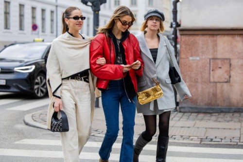 Trine Kjaer wears creme white top, pants, black bag & Anna Winck wears red leather jacket, denim jeans & Hanna Stefansson wears grey oversized...