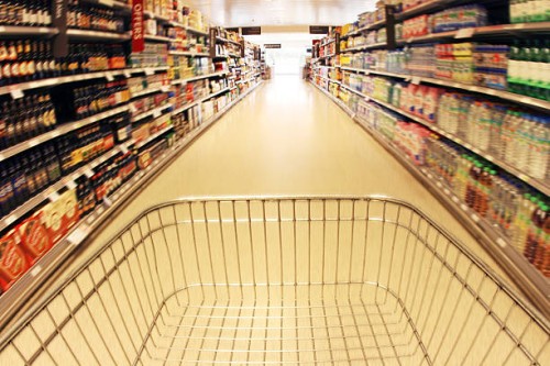 trolley in supermarket aisle - food stock pictures, royalty-free photos & images