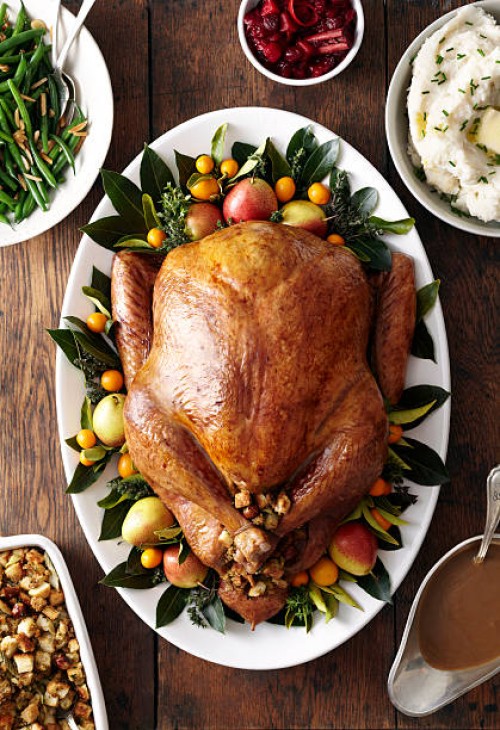turkey, stuffing, and gravy dishes on wood surface - food stock pictures, royalty-free photos & images