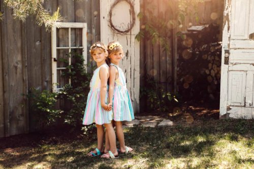 twin girls in garden - garden decoration stock pictures, royalty-free photos & images