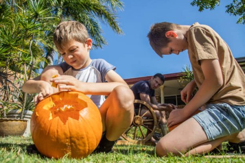 two boys carving pumpkins - garden decoration stock pictures, royalty-free photos & images