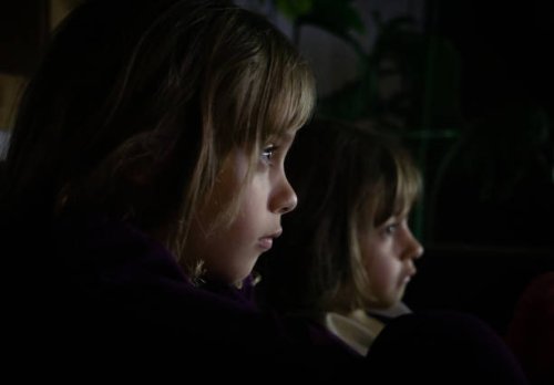 two children intently watching something - concert stock pictures, royalty-free photos & images