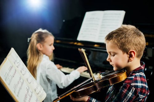 two children playing musical instruments. - concert stock pictures, royalty-free photos & images