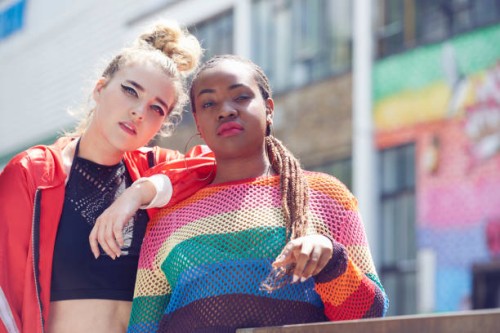 two fashionable young women in urban environment - fashion stock-fotos und bilder