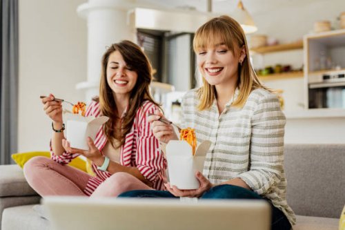 two female friends ordered pasta to eat at home - junk food stock pictures, royalty-free photos & images