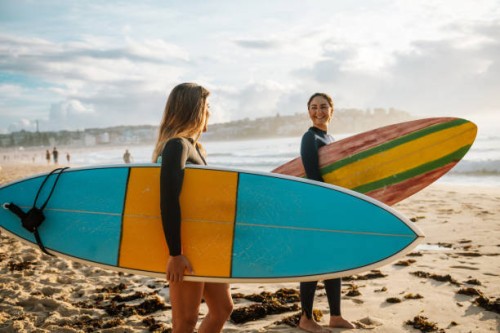 two female friends with surfboards - travel stock pictures, royalty-free photos & images