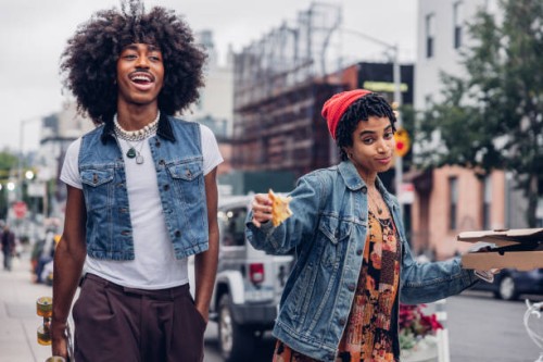 two friends eating pizza on the street - fashion stock pictures, royalty-free photos & images