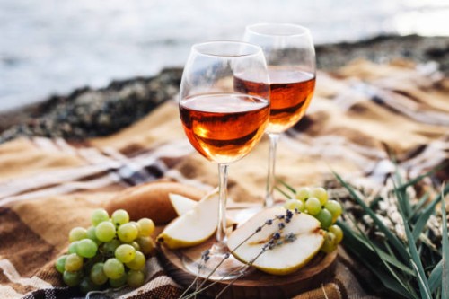 two glasses of wine and summer fruits on the beach, sea and landscape in background, summer picnic, idea for outdoor weekend activity - food stock pictures, royalty-free photos & images