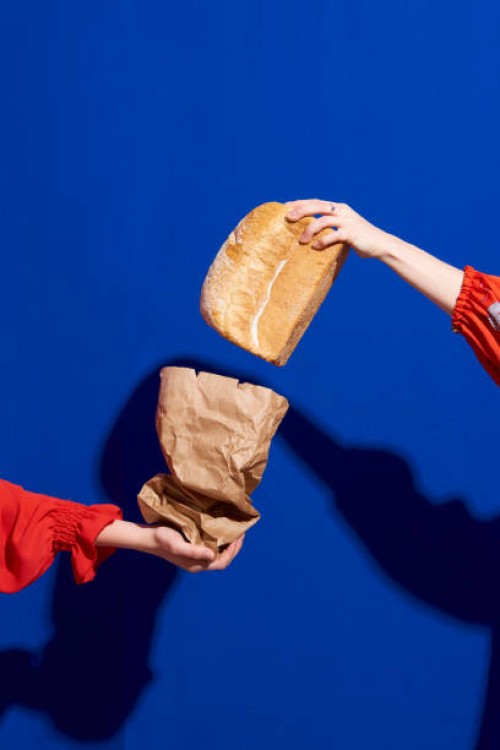 two hands with loaf of bread - food stock pictures, royalty-free photos & images