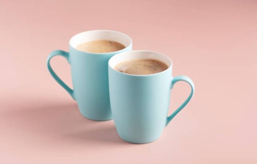 two light blue mugs with coffee stand on a powdery background,horizontal orientation,romania - coffee stock pictures, royalty-free photos & images