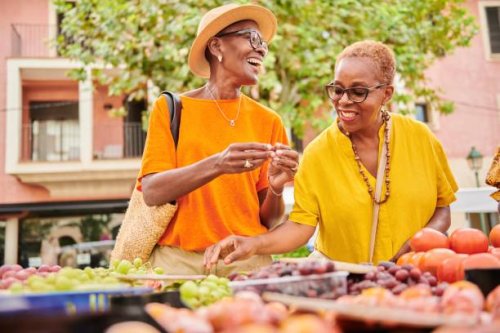 two mature women shopping together at an outdoor food market - travel stock pictures, royalty-free photos & images