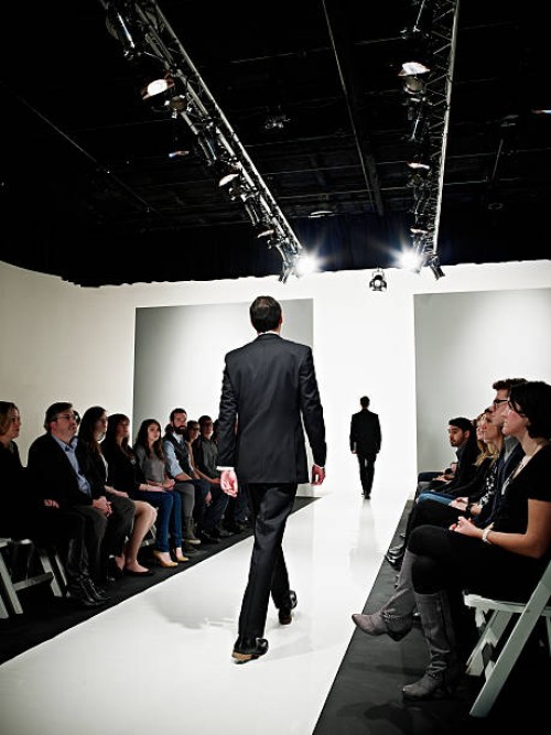 two models in business suits walking on catwalk - fashion stock pictures, royalty-free photos & images