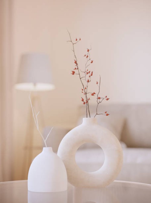 two modern white vases with brunches. white 3d rendering objects with blured interior background. minimalism japandi or scandinavian boho style - home decoration stock pictures, royalty-free photos & images