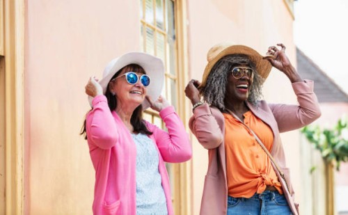 two multiracial senior women in sunglasses and sun hats - fashion stock pictures, royalty-free photos & images
