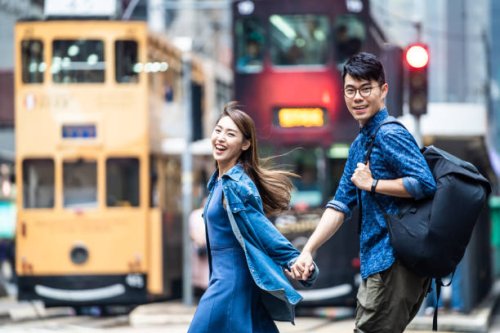 two people walking in hong kong and holding hands. - travel stock pictures, royalty-free photos & images